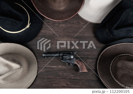 Gun with old west hats on table. Top view. 112200105