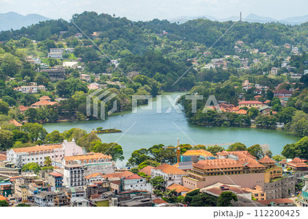 Scenery view of Kandy lake the beautiful stunning place in the heart of Kandy city, Sri Lanka. The lake, existing since 1807, has a flurry of idyllic places and historical structures around. Scenery view of Kandy lake the beautiful stunning place in the heart of Kandy city, Sri Lanka. The lake, existing since 1807, has a flurry of idyllic places and historical structures around. 112200425