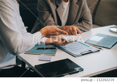 Business team working with new startup project plan and discussion information for financial strategy with laptop and digital tablet in a modern business lounge. 112202219