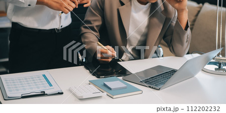 Young stressed Asian businessman working in the office. Businessman thinking too much work concept in the office. 112202232
