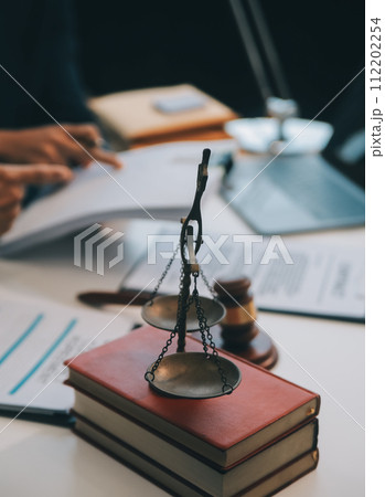 Consultation and conference of Male lawyers and professional businesswoman working and discussion having at law firm in office. Concepts of law, Judge gavel with scales of justice. Consultation and conference of Male lawyers and professional businesswoman working and discussion having at law firm in office. Concepts of law, Judge gavel with scales of justice. 112202254