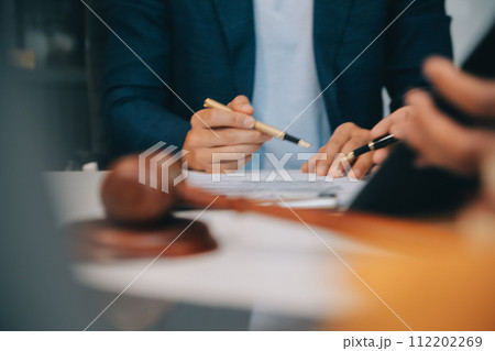 Consultation and conference of Male lawyers and professional businesswoman working and discussion having at law firm in office. Concepts of law, Judge gavel with scales of justice. Consultation and conference of Male lawyers and professional businesswoman working and discussion having at law firm in office. Concepts of law, Judge gavel with scales of justice. 112202269