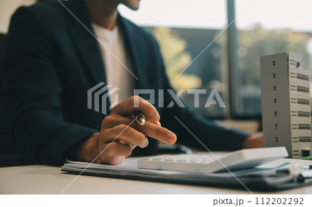 Real estate agent talked about the terms of the home purchase agreement and asked the customer to sign the documents to make the contract legally, Home sales and home insurance concept. 112202292
