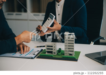 Real estate agent talked about the terms of the home purchase agreement and asked the customer to sign the documents to make the contract legally, Home sales and home insurance concept. 112202293