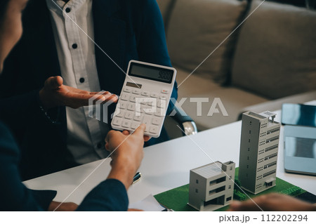 Real estate agent talked about the terms of the home purchase agreement and asked the customer to sign the documents to make the contract legally, Home sales and home insurance concept. 112202294