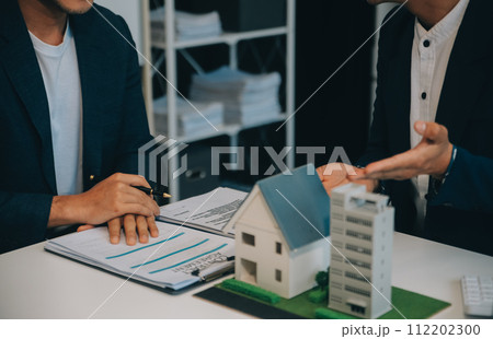 Real estate agent talked about the terms of the home purchase agreement and asked the customer to sign the documents to make the contract legally, Home sales and home insurance concept. 112202300