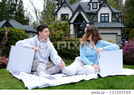Young boy and girl look at each other in the street Park box there is a place for the text delivery satisfied the right choice of technology walkNear the house in the garden picnic white boxes Young boy and girl look at each other in the street Park box there is a place for the text delivery satisfied the right choice of technology walkNear the house in the garden picnic white boxes 112203599