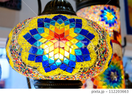 Multi-colored Turkish mosaic lamps on the ceiling market in the famous Grand Bazaar in Istanbul, Turkey Multi-colored Turkish mosaic lamps on the ceiling market in the famous Grand Bazaar in Istanbul, Turkey 112203663