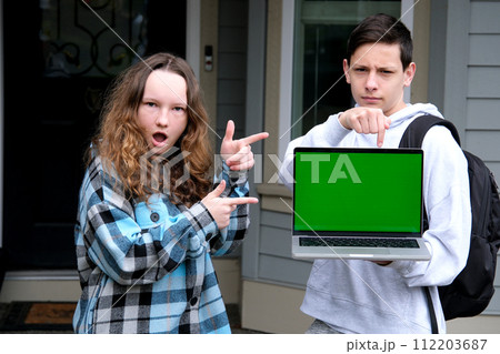 teenager boy teen girl dancing rejoicing showing fingers on green screen chroma key computer shoulders backpack laughter ad online learning podcast on platform for students school students teenagers 112203687