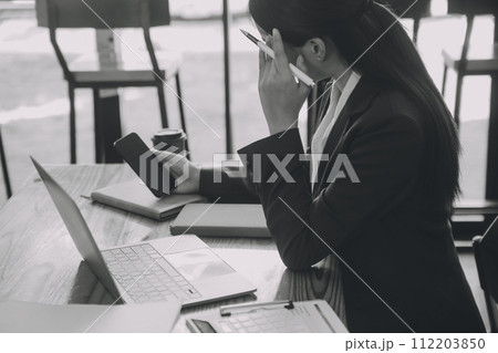 Asian women are stressed while working on laptop, Tired asian businesswoman with headache at office, feeling sick at work, copy space Asian women are stressed while working on laptop, Tired asian businesswoman with headache at office, feeling sick at work, copy space 112203850