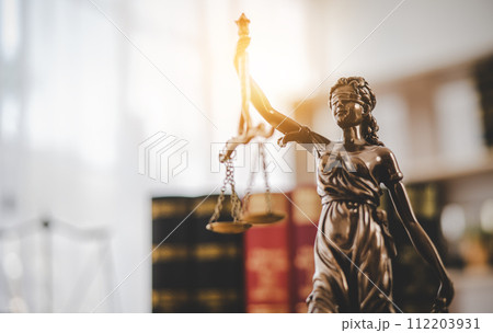 Lady Justice Holding Scales of Law in a Courtroom - Symbolizing Equality, Fairness, and Legal Proceedings Lady Justice Holding Scales of Law in a Courtroom - Symbolizing Equality, Fairness, and Legal Proceedings 112203931