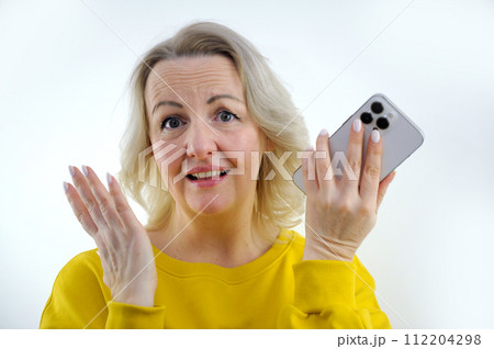 woman with phone in hands disappointed she raised eyebrows wide open eyes slight smile good looks upset surprised that this is how it could be price increase end of registration have time to apply woman with phone in hands disappointed she raised eyebrows wide open eyes slight smile good looks upset surprised that this is how it could be price increase end of registration have time to apply 112204298