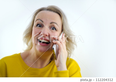 Portrait of attractive cheerful grey-haired woman sitting on divan talking on phone cellular at home house flat indoors 112204312