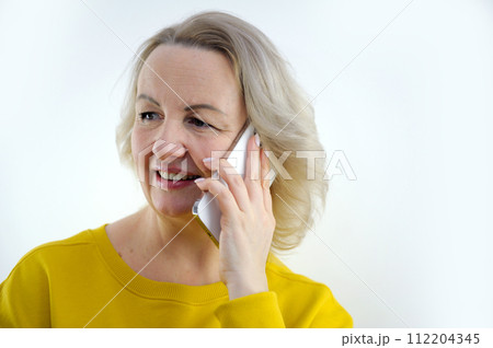 Caucasian woman use of mobile phone Caucasian woman use of mobile phone 112204345