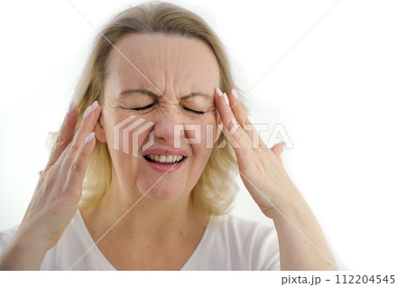 Attractive woman having a headache on white background Old woman with a headache holds her hands to her temples Attractive woman having a headache on white background Old woman with a headache holds her hands to her temples 112204545
