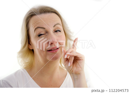 Attention listen to me. Close up portrait woman wagging her finger holding glasses skeptically isolated white grey wall background. Negative human emotion face expression body language attitude 112204573