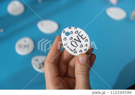 Master class writing word LOVE on EASTER egg Children air dry clay activity handicraft idea. DIY process step by step instruction. Preparing for Easter holiday decorating. Modern organic design 112204590