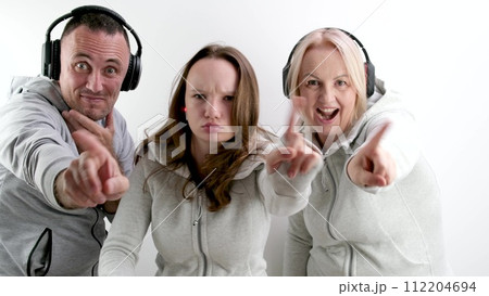 man and two women teenage girl doing negative Swing with index finger No don't do it look into the frame extending hand with finger forward headphones tracksuits white background man and two women teenage girl doing negative Swing with index finger No don't do it look into the frame extending hand with finger forward headphones tracksuits white background 112204694