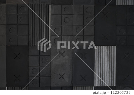 Textured black, gray geometric background made of concrete with stripes, squares, circles, crosses, tic-tac-toe, copy space. Concept of modern abstract creative wall design with bulky convex elements. Textured black, gray geometric background made of concrete with stripes, squares, circles, crosses, tic-tac-toe, copy space. Concept of modern abstract creative wall design with bulky convex elements. 112205723