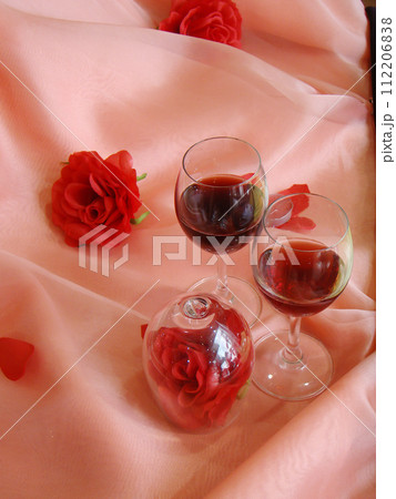wine and glass with roses background wine and glass with roses background 112206838
