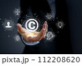 Concept of protecting and protecting against copyright infringement. The hand of a business person is holding a copyright icon. 112208620