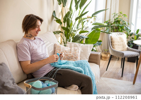 Hipster feminine male crochet handmade knitting hobby with colored yarn and hook at white interior 112208961