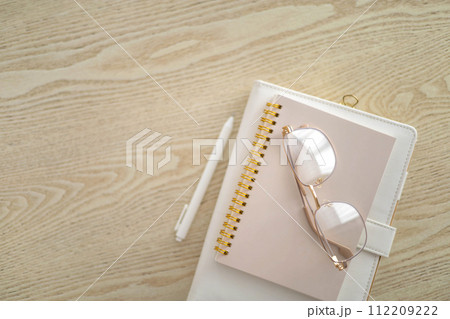 Business planning time management job organization concept stack of notepad on wooden table top view 112209222