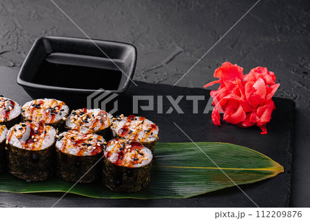 Traditional fresh japanese sushi futomaki on black stone 112209876
