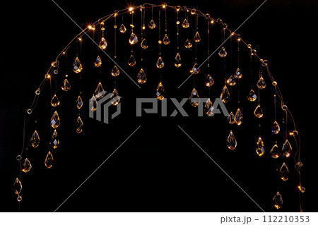 AI-generated content. Crystal Beads Dangling with Golden Light Reflections 112210353