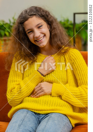 Child girl laughing out loud after hearing ridiculous anecdote, funny joke, feeling carefree amused 112210882