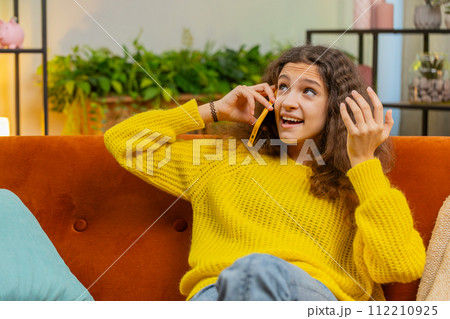 Happy surprised child girl having pleasant conversation phone call good news enjoying talking gossip 112210925