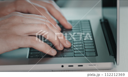 Man hands typing on laptop close up. Online project, report research at desk. Planning, business, freelancer student using laptop studying online working from home in internet. Blue toning side view 112212369