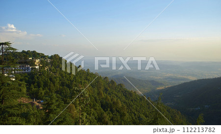 A vast landscape with clear skies, clouds, and snowy mountains. 112213782