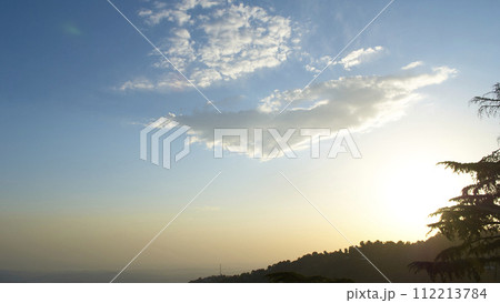 A vast landscape with clear skies, clouds, and snowy mountains. 112213784