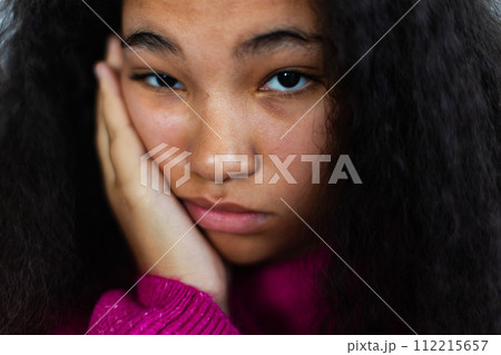 Portrait of bored woman holding her head in hand, looking at camera. 112215657