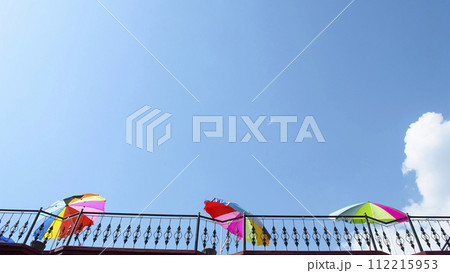 Colorful parasols visible against the background of the blue sky. 112215953