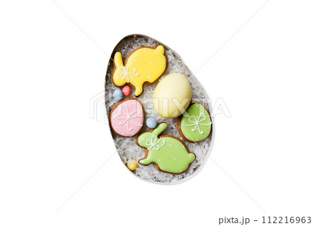 Colorful easter cookies in basket with Multi colors Easter eggs isolated on white background. Pastel color Easter eggs. holiday concept Colorful easter cookies in basket with Multi colors Easter eggs isolated on white background. Pastel color Easter eggs. holiday concept 112216963