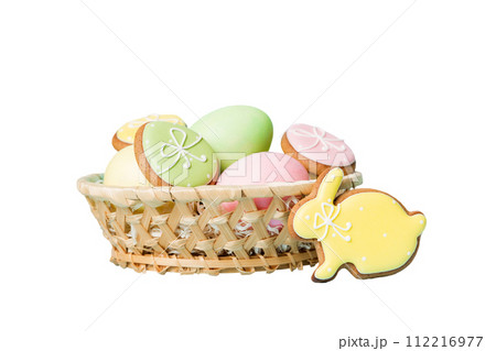 Colorful easter cookies in basket with Multi colors Easter eggs isolated on white background. Pastel color Easter eggs. holiday concept 112216977