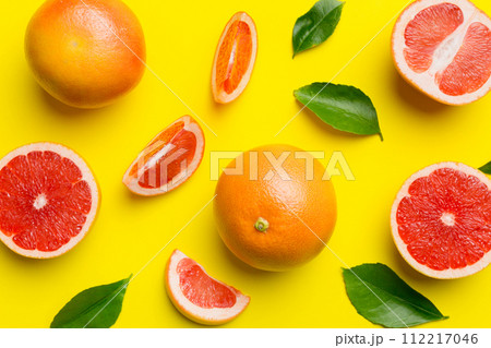 fresh Fruit grapefruit with Juicy grapefruit slices on colored background. Top view. Copy Space. creative summer concept. Half of citrus in minimal flat lay with copy space 112217046
