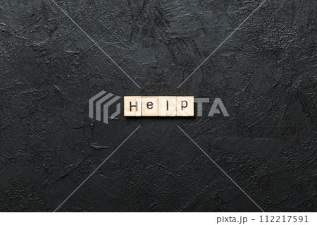 Help word written on wood block. Help text on table, concept 112217591