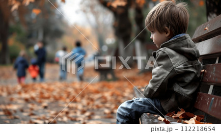 Thoughtful Boy Sitting Alone in Park 112218654