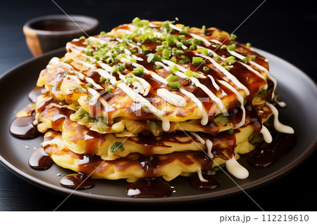 Pancakes with Chinese cabbage and sauce on a black background 112219610
