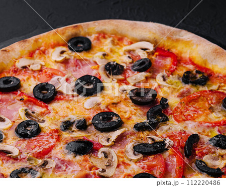 Pizza with tomato, olives, champignons, ham and cheese Pizza with tomato, olives, champignons, ham and cheese 112220486