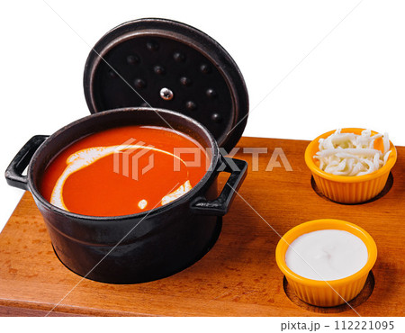 Tomato soup gazpacho in stewpan and suluguni cheese 112221095