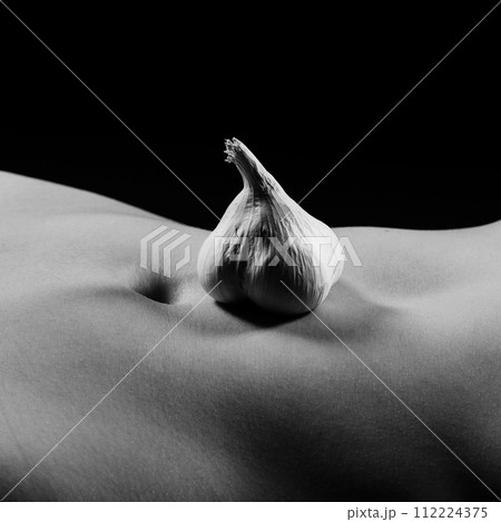 Young nude woman with garlic, naked body Young nude woman with garlic, naked body 112224375