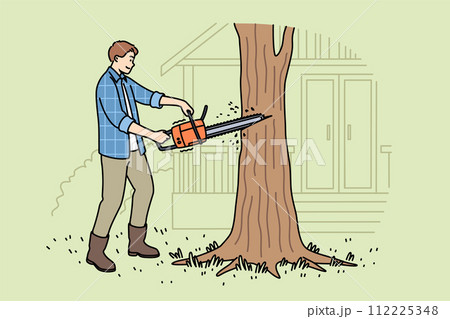 Man lumberjack uses chainsaw to get rid of old, diseased tree growing near house 112225348