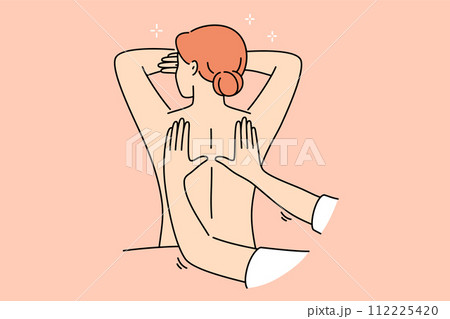 Woman attends massage treatments in SPA salon lying with bare back and enjoying rejuvenation therapy 112225420