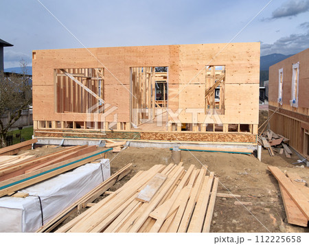 Wooden frame of a new house with engineered lumber materials in front Wooden frame of a new house with engineered lumber materials in front 112225658