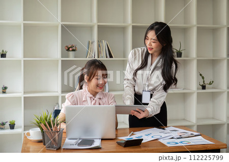 Two businesswoman discussing partner discussing project on laptop in office. Two colleague of professional business people working together at workspace Two businesswoman discussing partner discussing project on laptop in office. Two colleague of professional business people working together at workspace 112225799