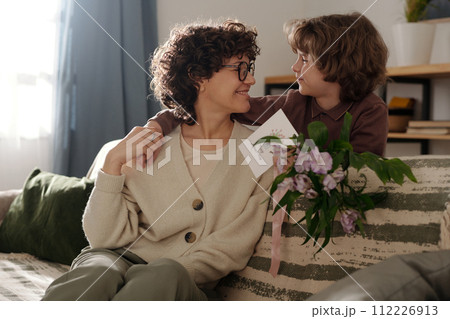 Boy embracing mother during celebration 112226913
